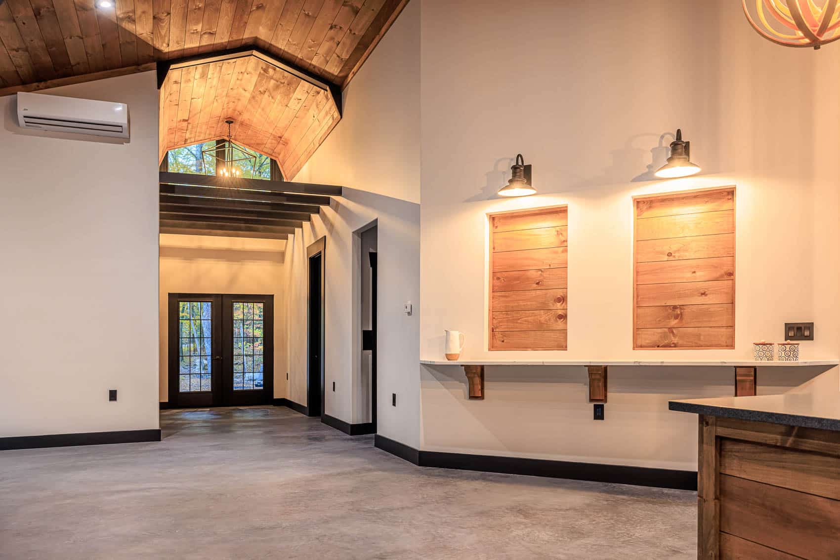 Interior living space with vaulted wood ceiling and warm lighting